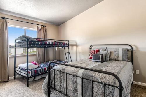 a bedroom with two bunk beds and a window at Sunset Vista in Garden City