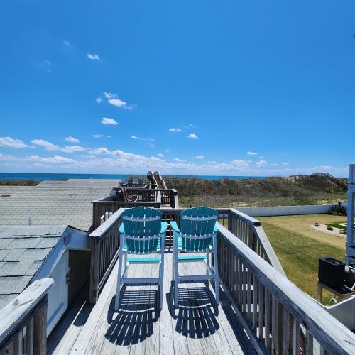 two chairs on a deck looking out at the ocean at NC 12 56821-9 Condo in Hatteras