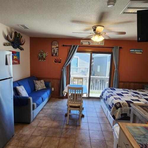 a living room with a couch and a bed at NC 12 56821-9 Condo in Hatteras