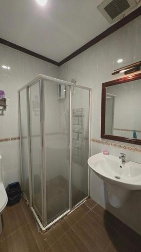 a bathroom with a shower and a sink at DaViKa Vientiane Hotel in Vientiane