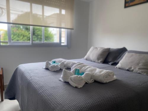 a bed with folded towels on top of it at Namante in Balcarce