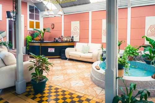 an outdoor patio with plants and a pool at The Nomad Hostel - SJO Airport San Jose 5 min - Private, WiFi & Coffee in Alajuela