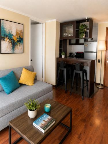 a living room with a couch and a table at Departamentos Amoblados Torre Tagle in Santiago