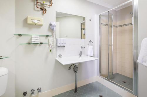 a bathroom with a sink and a shower at Metro Hotel Perth City in Perth