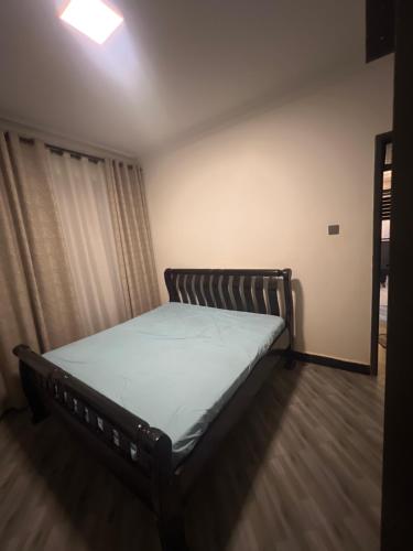 a bedroom with a bed in a room at AJ Space in Kampala