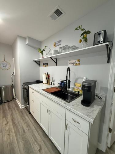 a kitchen with a sink and a counter top at Cozy and Chic Burlington Retreat in Burlington