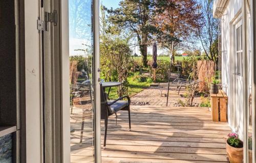 an open door to a patio with a table and chairs at 4 Bedroom Gorgeous Home In Stege in Stege