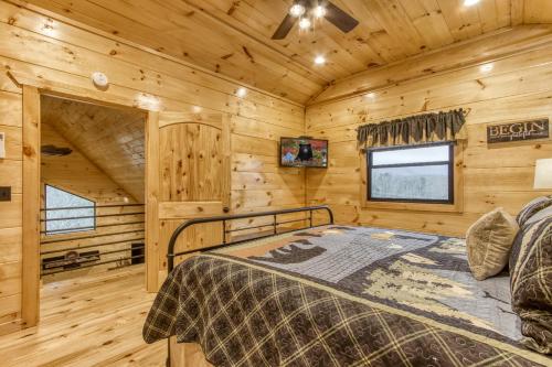 a bedroom with a bed in a wooden cabin at Bear Bottom View in Sevierville