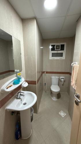 a bathroom with a sink and a toilet at Sharjah Room in Sharjah