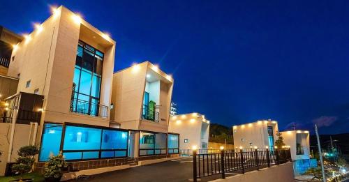 a large building at night with lights on at Gaza Spa Pool Villa Yeosu in Yeosu