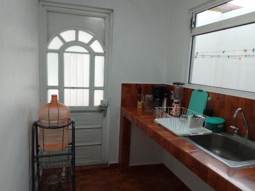 a kitchen with a counter and a sink and a window at Gran Tonantzin in San Martín de las Pirámides