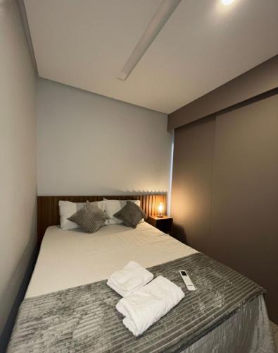 a bedroom with a bed with towels on it at risorte eco carneiros in Tamandaré