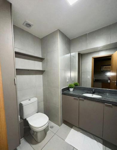 a bathroom with a toilet and a sink at risorte eco carneiros in Tamandaré