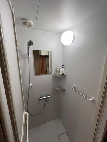 a bathroom with a shower and a mirror at 十度-jude- in Osaka