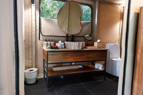 a bathroom with a vanity with a mirror and a sink at Serenity Sands Island Glamping in Bounty Island