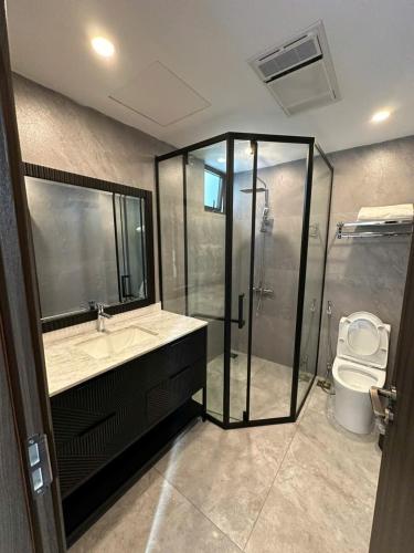 a bathroom with a shower and a sink and a toilet at Villa Florent in Thanh Hóa