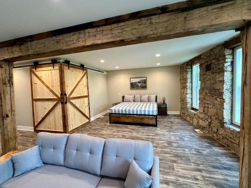 a living room with a bed and a large barn door at Grand River Suite in Bellevue