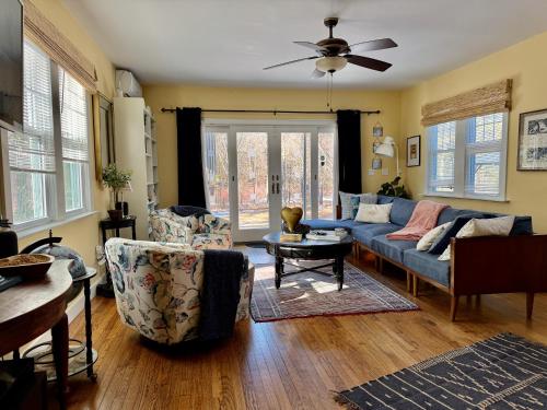 a living room with a blue couch and chairs at 1890 CapeCod farmhouse:Charming, Private, Spacious in Saugerties