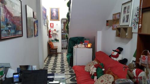 a living room with a red couch with stuffed animals at Anccalla Inn Guesthouse in Nazca