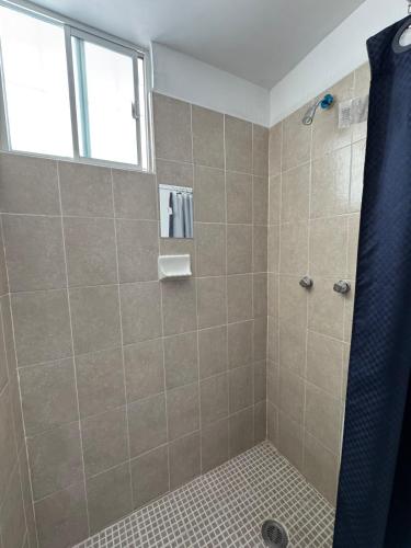 a bathroom with a shower with a window at Equipped house in Salinas industrial zone in Ciudad Satelite del Norte