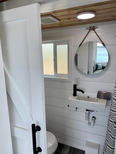 a bathroom with a sink and a mirror at The River's Edge (Tiny Home 3) in Bellevue