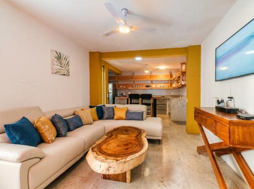 a living room with a couch and a wooden coffee table at Zihua Mia Hotel Boutique in Zihuatanejo