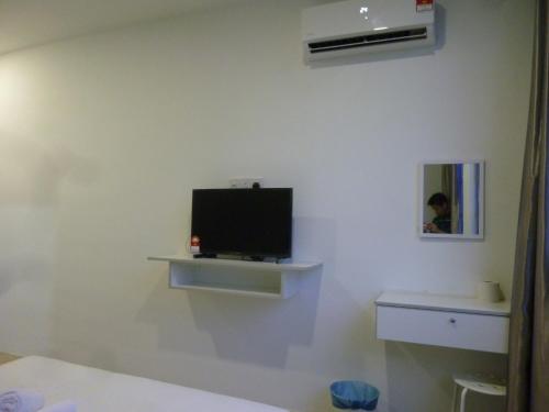 a room with a tv on a wall at The b'Hotel in Kajang