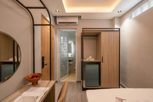 a bathroom with a mirror and a sink in a room at The Cozy Hotel in Ho Chi Minh City