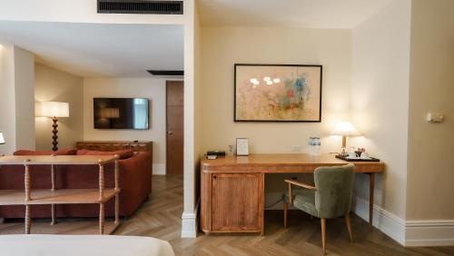 a hotel room with a desk and a living room at Sugar Marina Hotel - FASHION - Kata Beach in Kata Beach