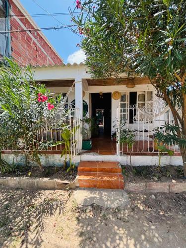 a white house with a gate and a porch at Isla fuerte House in Puerto Limón