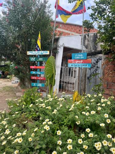 a bunch of signs in a garden with flowers at Isla fuerte House in Puerto Limón