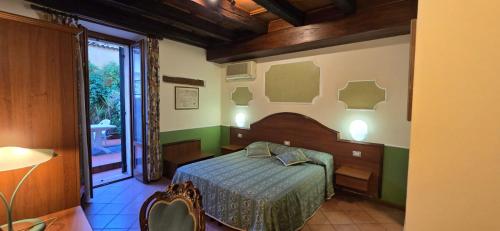 a bedroom with a bed in a room with a window at Cavour rooms in Verona