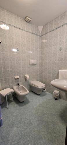 a bathroom with a sink and a toilet and a bidet at Cavour rooms in Verona