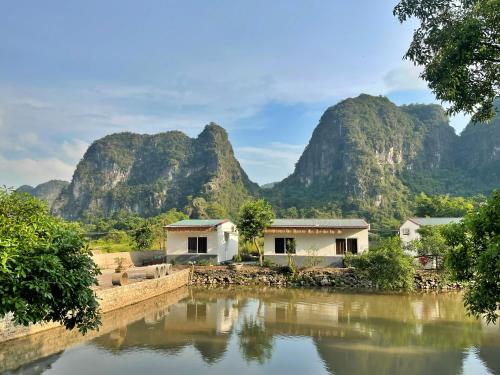 a view of a river with mountains in the background at Trang An Pristine View Homestay in Ninh Binh
