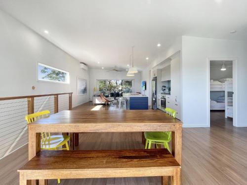 a dining room with a wooden table and yellow chairs at Pet-Friendly 3-Bed Coastal Gem Near Long Beach in Long Beach