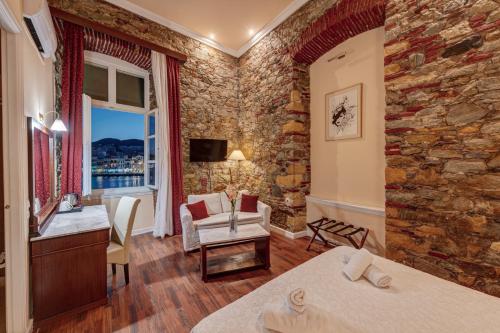 a hotel room with a stone wall at Hotel Aktaion Syros in Ermoupoli