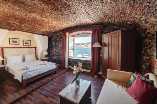 a hotel room with a bed and a window at Hotel Aktaion Syros in Ermoupoli