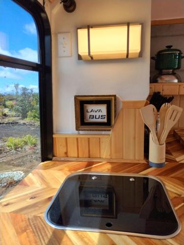 a view of a kitchen in a tiny house at Lava Bus in Hawaiian Ocean View