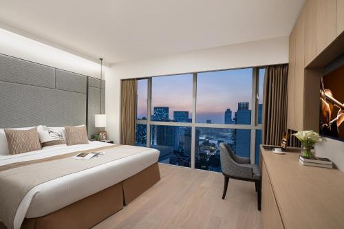 a bedroom with a large bed and a large window at Ascott Guangzhou in Guangzhou