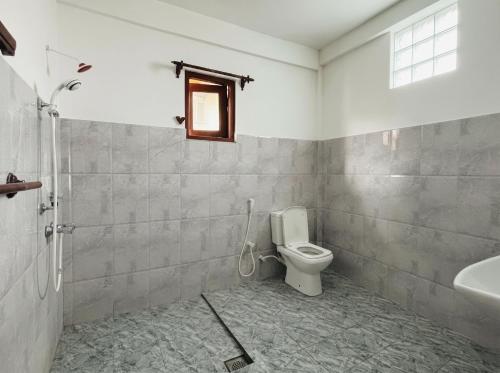 a bathroom with a toilet and a sink at Villa Dream D in Hikkaduwa