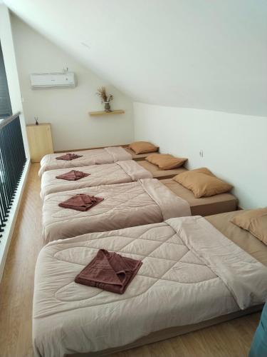 a group of four beds in a room at Shania home in Bogor