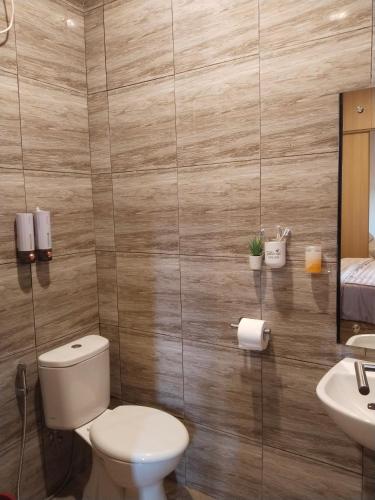 a bathroom with a toilet and a sink at Shania home in Bogor