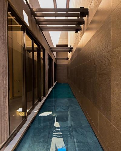 a hallway of a building with a pool of water at Amorita Resort Palawan in Puerto Princesa