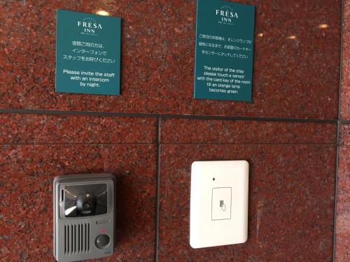 a box with an electrical outlet on a wall at Sotetsu Fresa Inn Fujisawa Shonandai in Fujisawa