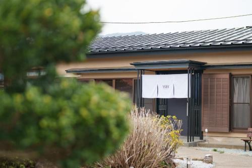 a house with a sign on the side of it at WTN Way too nice in Fujikawaguchiko