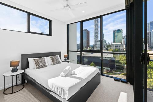 a bedroom with a bed with a teddy bear on it at Brisbane Skyline View 2Beds River view Apt in Brisbane