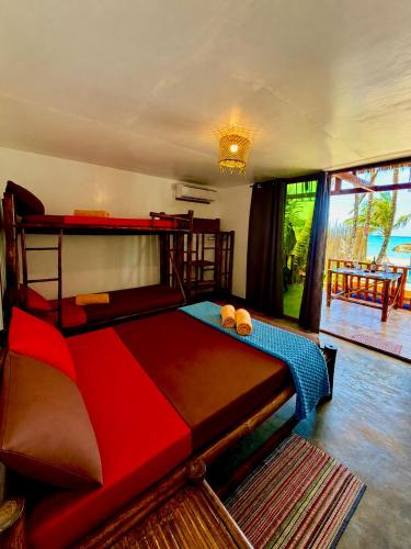 a bedroom with a large bed in a room at Beachfront Bungalows Bucana, El Nido in El Nido