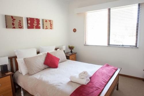 a bedroom with a bed with two towels on it at TorquayToongahra BnB in Torquay