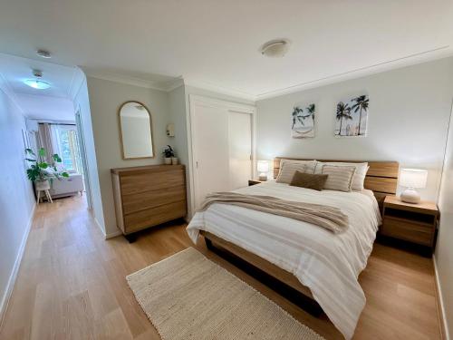 a bedroom with a large bed in a room at Sussex View - Waterfront Couples Retreat in Sussex Inlet in Sussex Inlet
