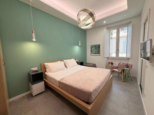a bedroom with a bed and a green wall at Veniero37 Guest House in Rome